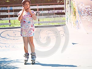 The little girl with roller skates arranging her helmet