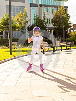 Little girl on roller skates in helmet