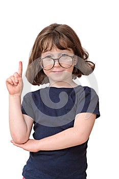 Little girl in round spectacles raising finger in