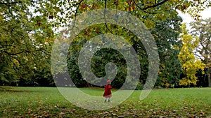 Little girl running across field to her mother