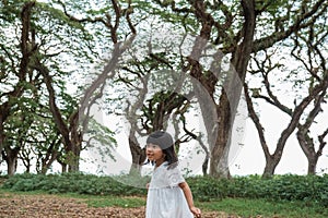 Little girl running around the forrest