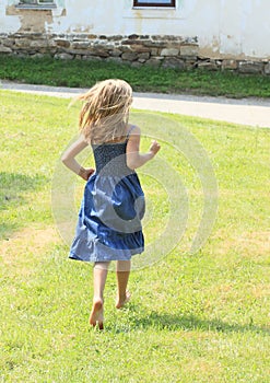 Little girl running barefoot