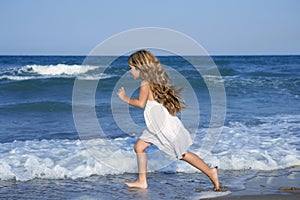 Little girl running beach in blue sea