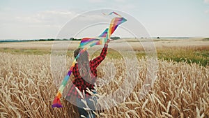 little girl running with a kite. happy family kid dream concept. a child plays in the park runs with a kite in a field