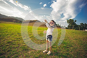 Little girl running with kite happy and smiling on summer field