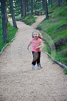 Little girl running outdoor at the mountain