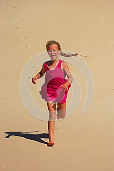 Little girl running in sand
