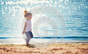 Little girl running at the sea