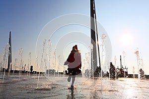 Little girl running through street fountains in southend on sea