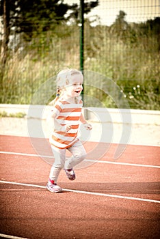 Little girl running on the treadmill