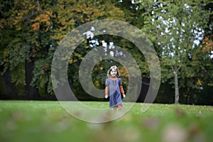 Little girl runnning in the park