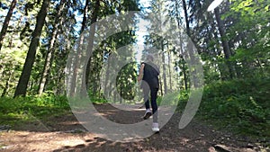 Little girl runs along a forest path in summer. Slow motion