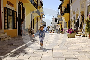 A little girl runs happily in the picturesque Italian village. San Felice Circeo, Lazio, Italy photo