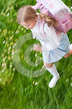 Little girl rushing to school photo