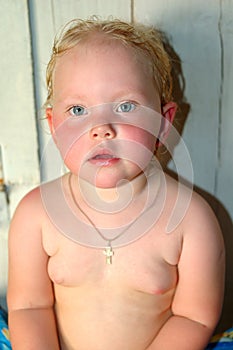 Little girl after Russian baths sit in bathhouse. photo