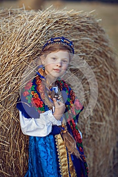 Little girl in Russian costume in the field