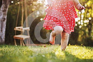 Little girl`s bare feet in the grass.