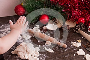 Little girl`s hand makes christmas cookies