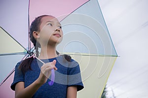 Little girl`s hold umbrella smile and looking at on the rainy s