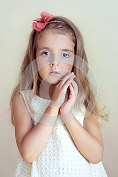 Little girl's portrait. Tender serious child, fashion model.