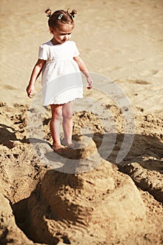 Little girl on sandy beach