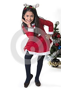 Little girl in Santa Claus costume and Reindeer antlers