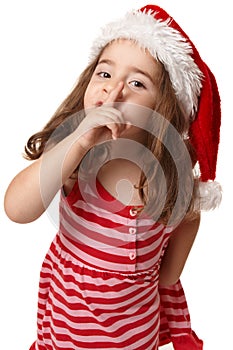 Little girl in santa hat gesturing peace and quiet