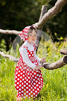 A little girl in a sarafan.