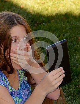 A little girl scared of what she sees online. photo