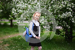 Little girl with a school backpack. The concept of school, study, education, friendship, childhood