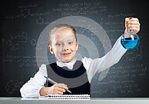 Little girl scientist examining test tube