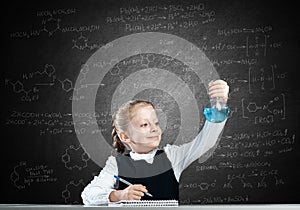 Little girl scientist examining test tube