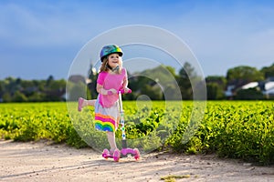 Little girl on a scooter