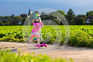 Little girl on a scooter