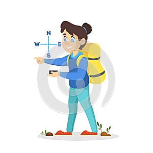 Little girl scout with a backpack looking at the compass