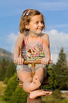 Little girl on the seesaw photo