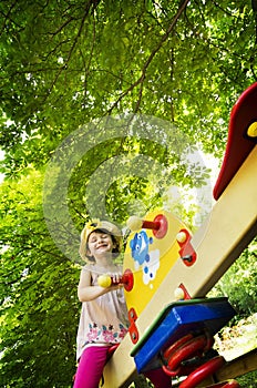 Little girl on seesaw/teeter-totter photo