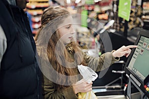 Little Girl at Self Service Checkout