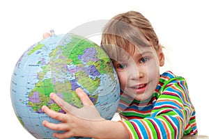 Little girl in shirt play with inflatable globe