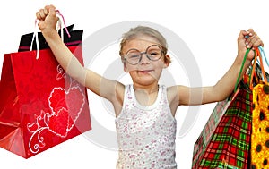 Little girl with shopping bags on white background