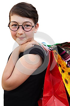 Little girl with shopping bags on white background