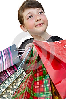 Little girl with shopping bags on white background