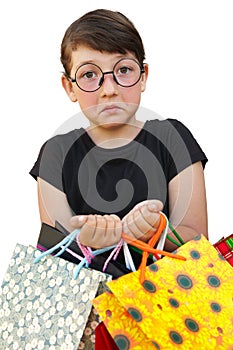 Little girl with shopping bags on white background