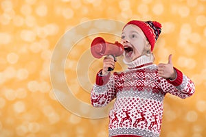 Little girl shouts something into the megaphone