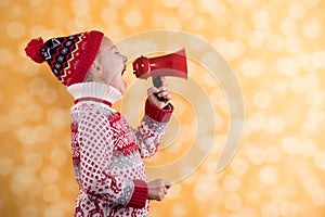 Little girl shouts something into the megaphone