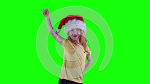 Little girl showing forbid prohibit gesture with finger. green background.