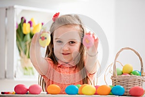 Little girl showing her hand-painted colorful eggs.