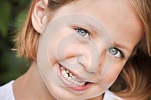 Little girl showing her white teeth