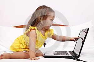 Little girl showing a laptop screen