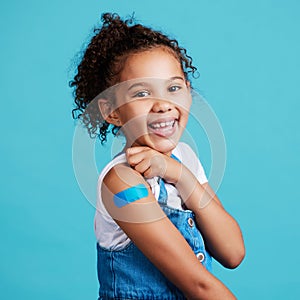 Im a big girl now. a little girl showing off a bandaid on her arm.